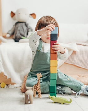 A young girl playing here toys.