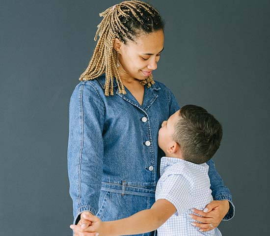 A heartfelt hug between a woman and a boy, symbolizing love and closeness in their relationship.