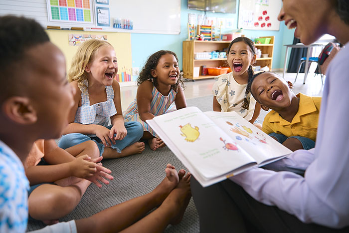 Educator reading a story to attentive children