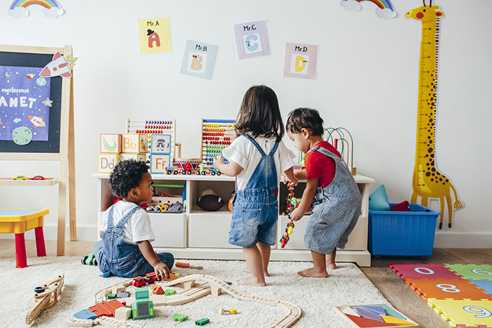 Children playing in a cozy, home-like daycare environment